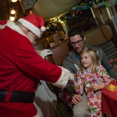 Santa entertaining kids inside train