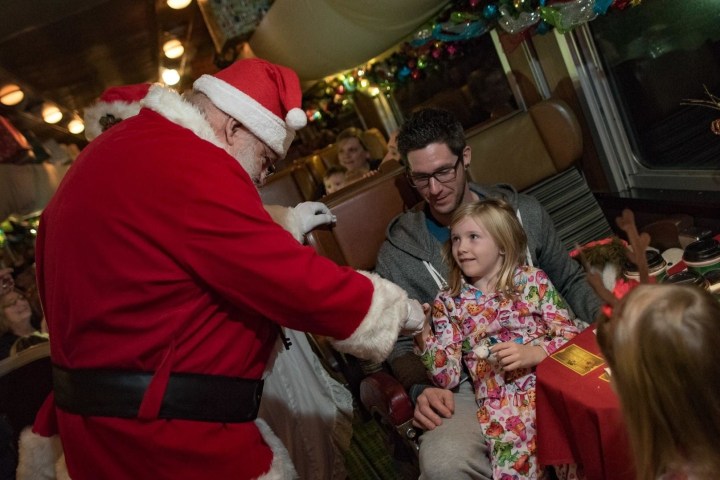 Santa entertaining kids inside train