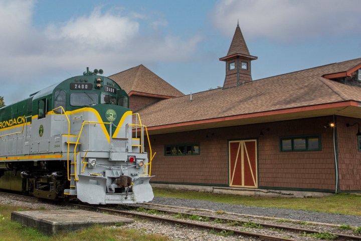 a train is parked on the side of a building