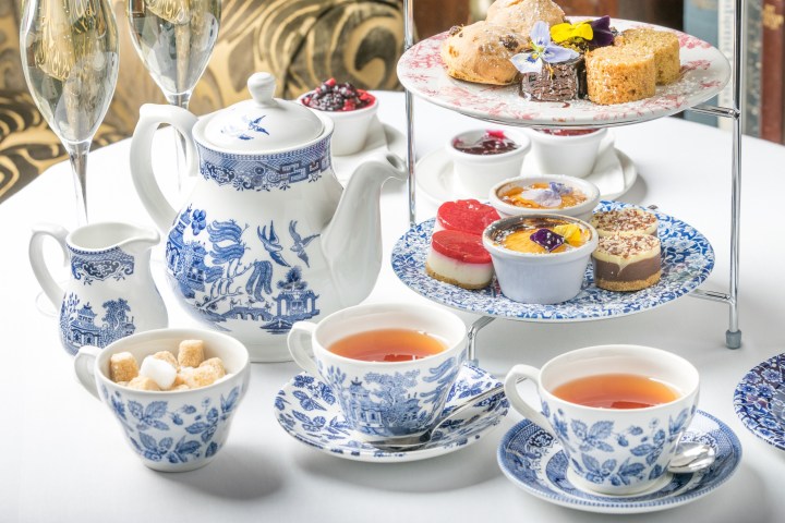 a table topped with plates of food and a cup of coffee