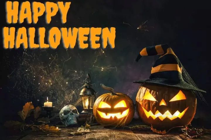 Lit pumpkins and skull with 'Happy Halloween' text on dark background.